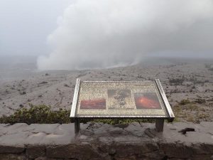 Ash-covered sign at Jaggar Museum viewing area on May 17, 2018